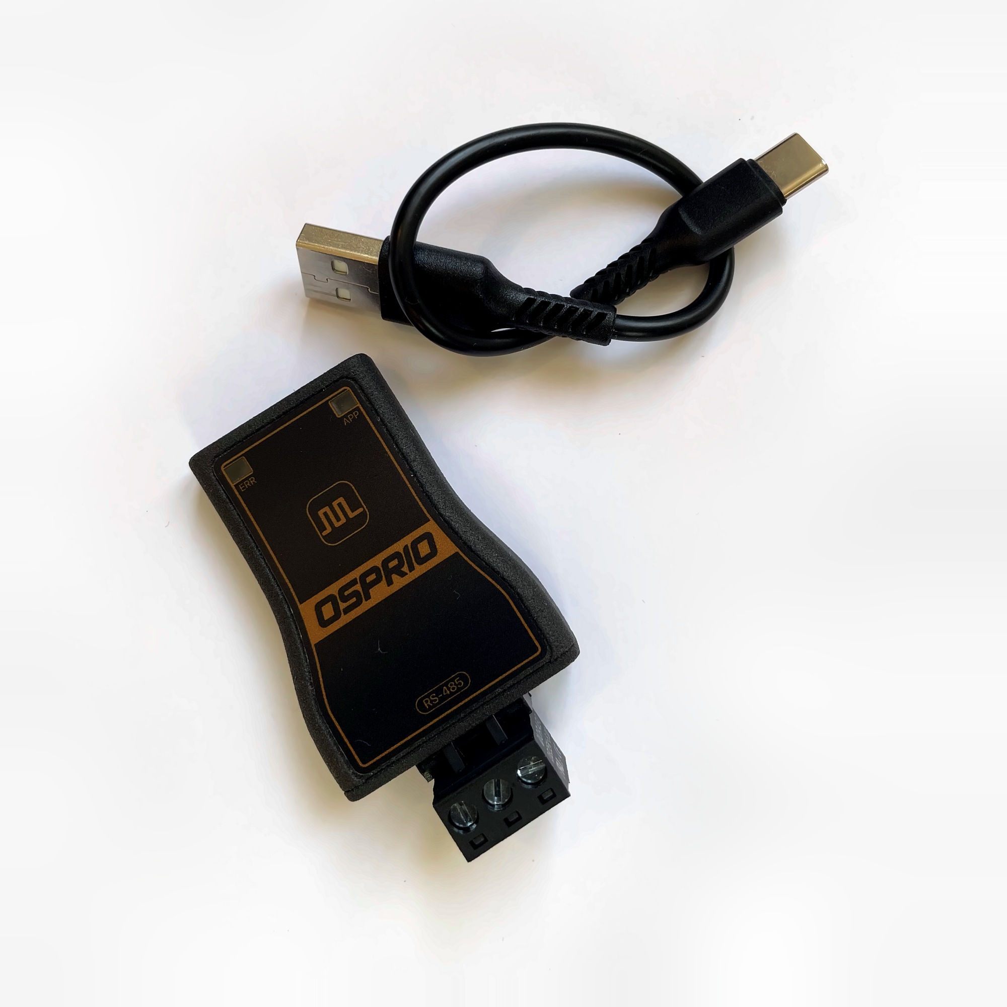 Osprio Mini lying beside its USB-C cable, with the pluggable screw terminal fitted