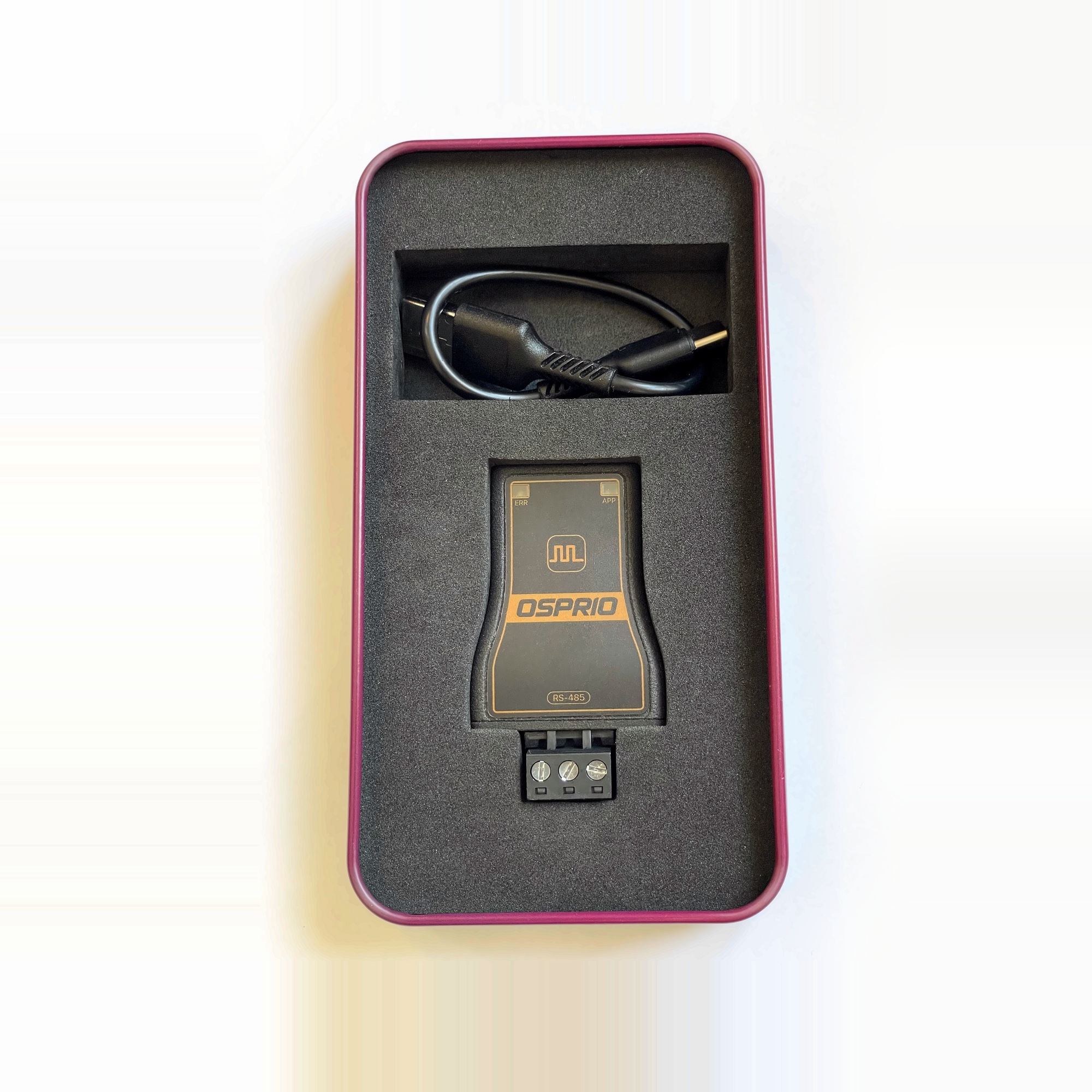 Osprio Mini and cable seated in the foam insert of the open tin
